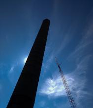 Takedown of old tannery smokestack on Crowninshield St. with demolition crane