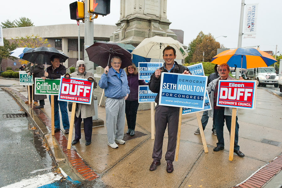 Peabody Democrats hold signs in rain